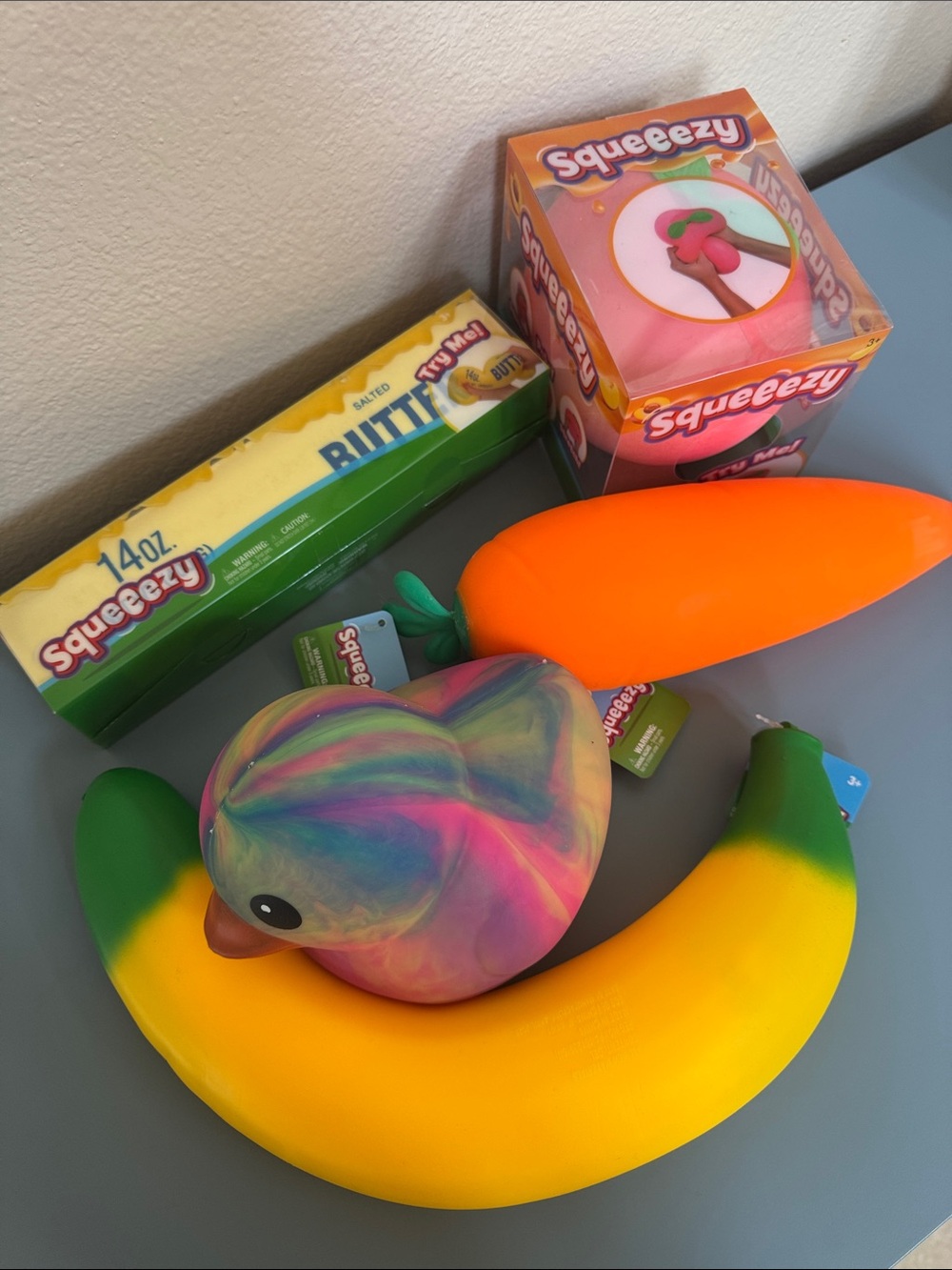 Squeezy Squishy Fruit & Duck Bundle - Rainbow Duck, Banana, Carrot, Butter Toy
